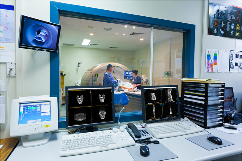 MRI machine and screens showing ProtonPACS software